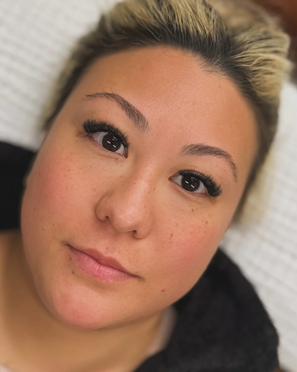 Client portrait showing full lashes and softly defined brows